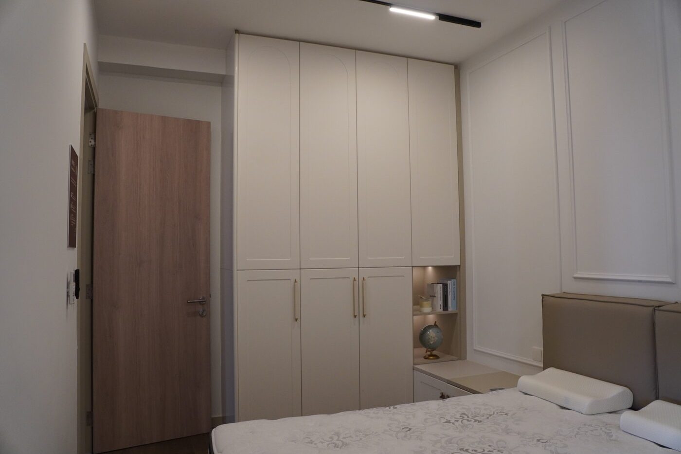 Bedroom with a floor-to-ceiling built-in wardrobe beside the bed